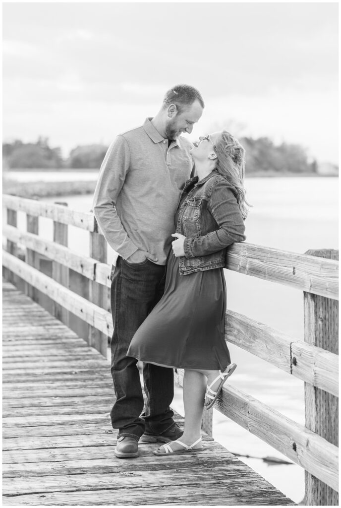 couple laughing near the lake at Norwalk Reservoir engagement session