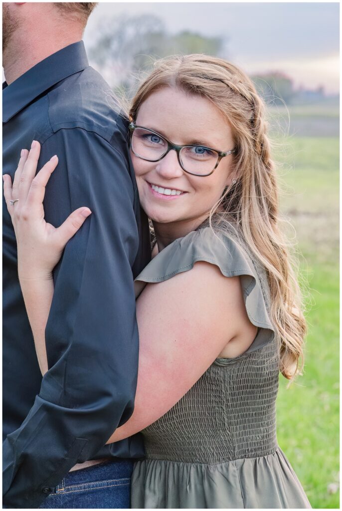 woman hugging her fiance from behind at engagement session in Tiffin, Ohio