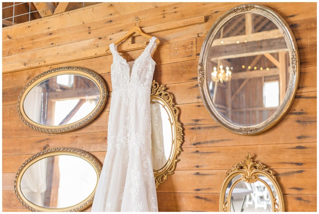 bride's wedding dress hanging from a wooden wall in Tiffin, Ohio