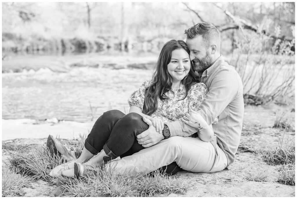 couple sitting together next to a creek at Lindsey, Ohio engagement session