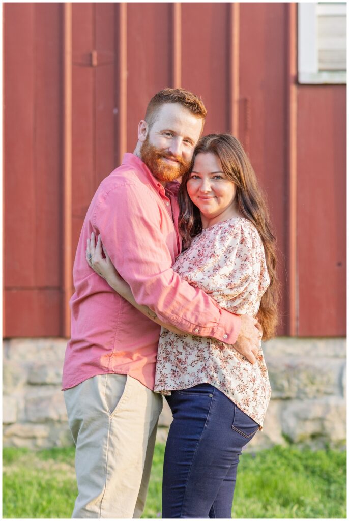 couple posing in front of a red barn at Lindsey, Ohio engagement session