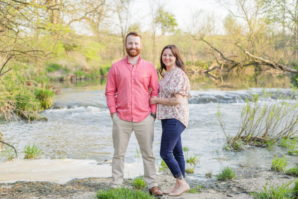 engaged couple posing next to a creek at Ohio session 