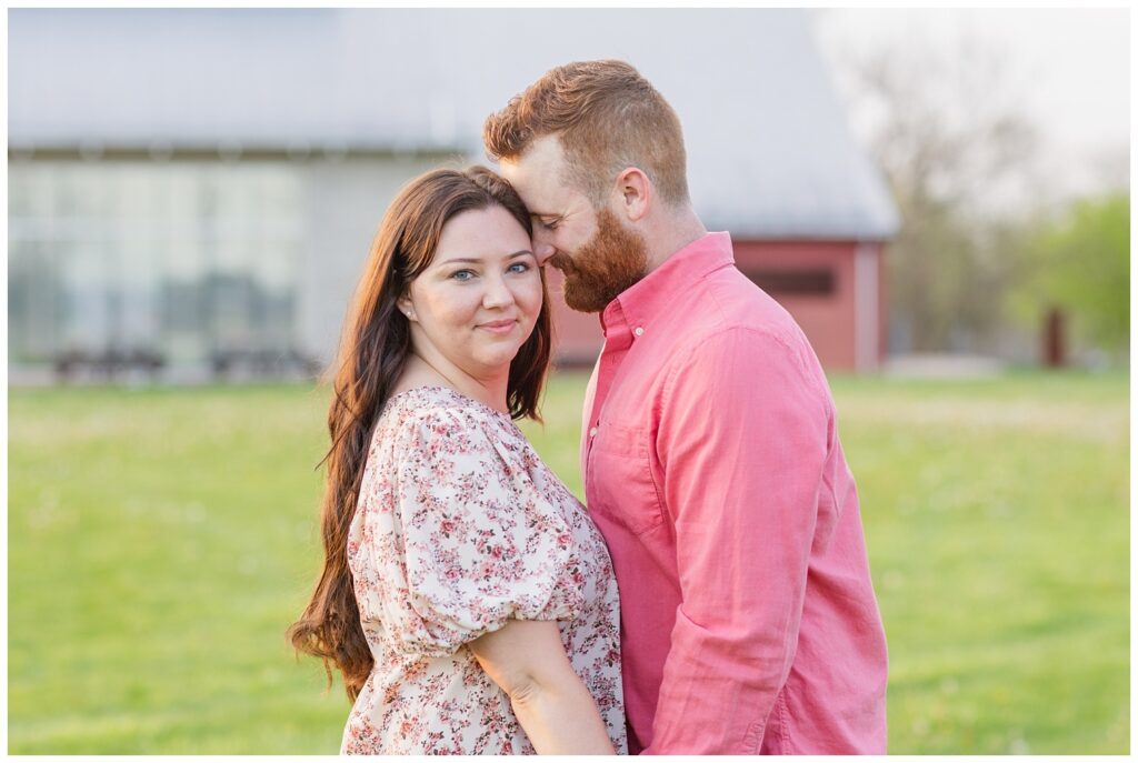 couple holding hands and smiling at golden hour engagement session in Ohio