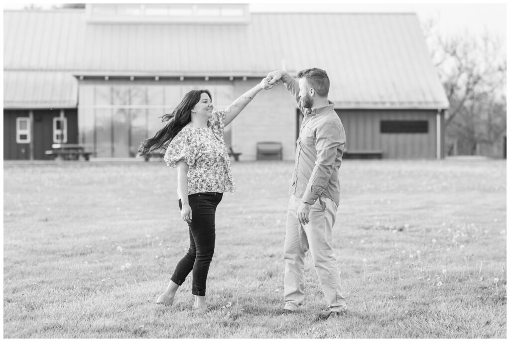 couple twirling together at Creek Bend Farm engagement session