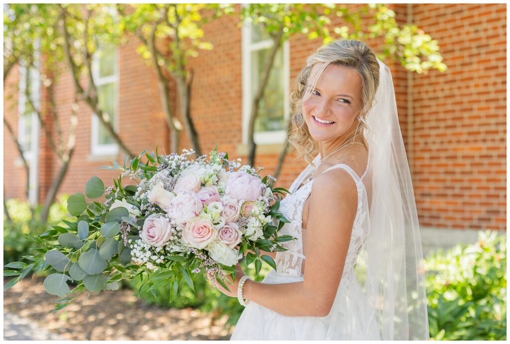 bride holding her bouquet and looking back at a church wedding in Dublin, Ohio