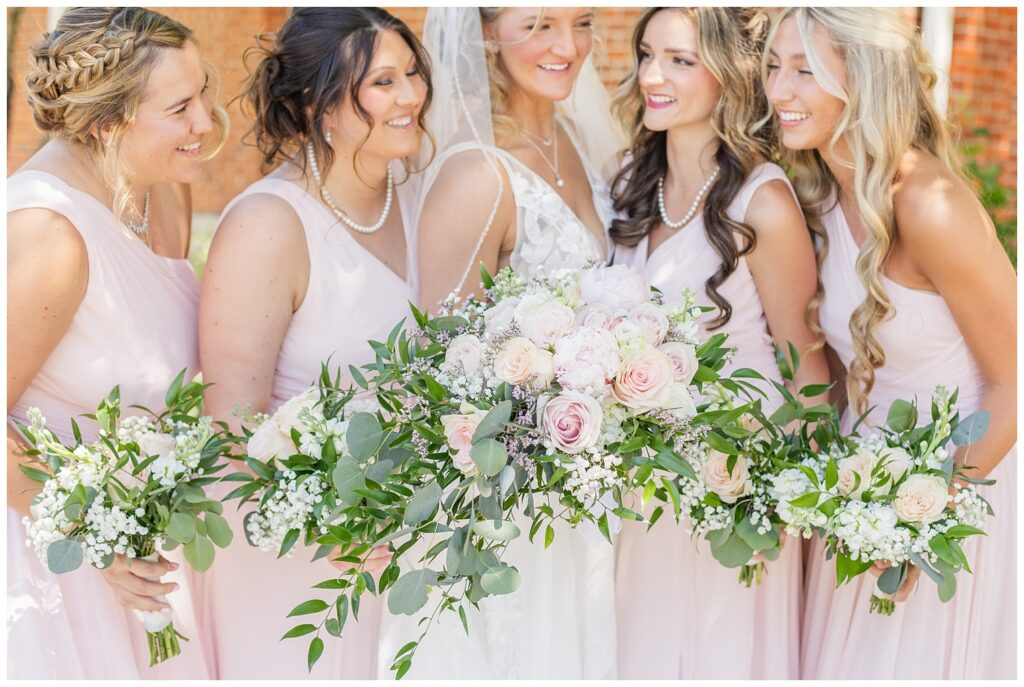 close up of bride's and bridal party bouquets outside under the trees in Dublin, Ohio