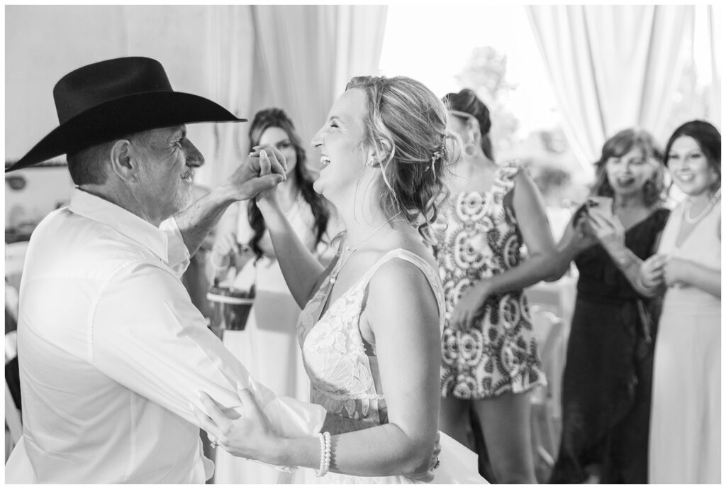 bride dancing with a wedding guest during barn reception at Prairie Stone Farm