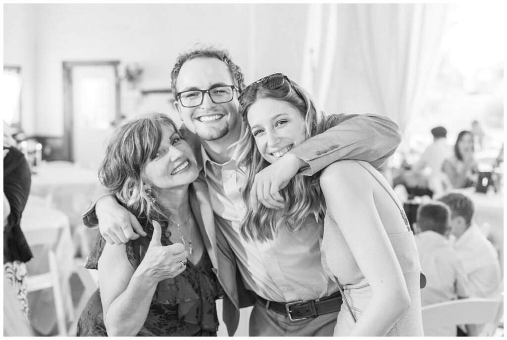 wedding guests posing for portraits at summer reception at barn venue in Ohio