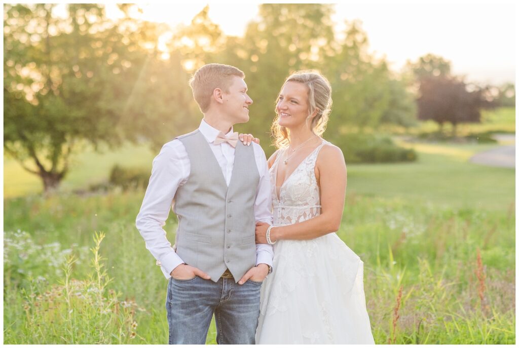 bride and groom posing for couples portraits with the groom wearing jeans