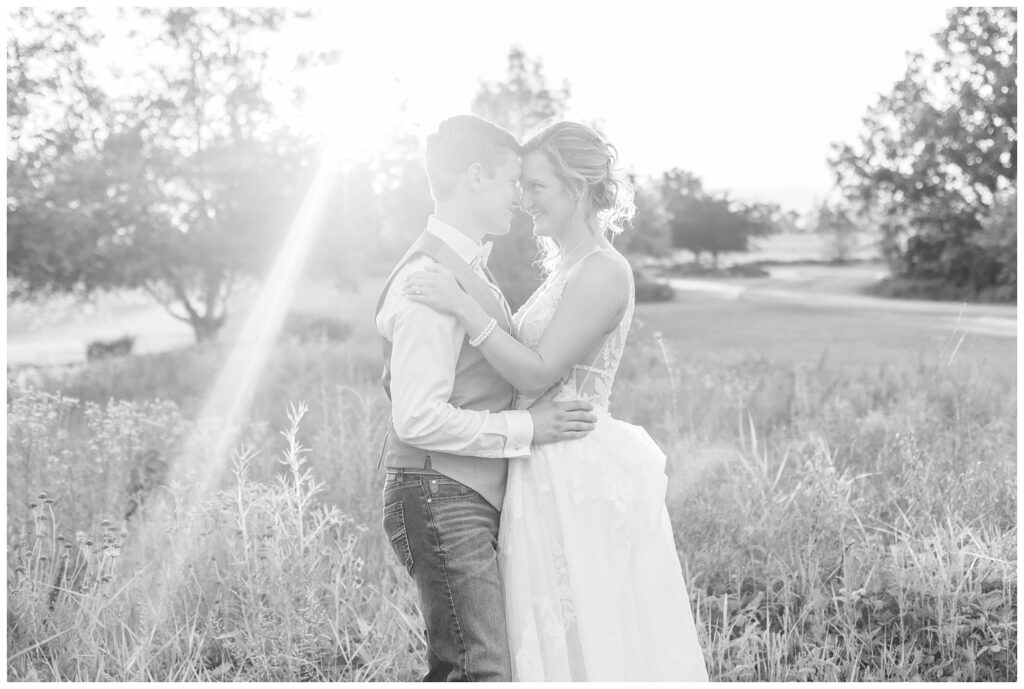 wedding portraits of the bride and groom in a field during golden hour 