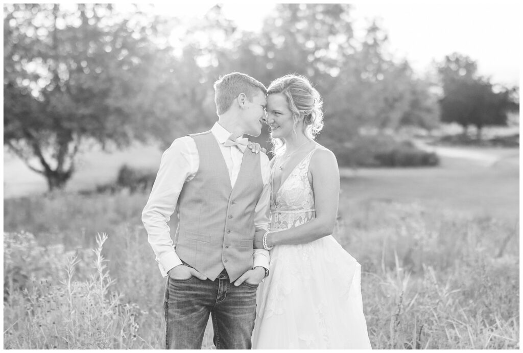 wedding portraits of the bride and groom in a wildflower field at Prairie Stone Farm venue