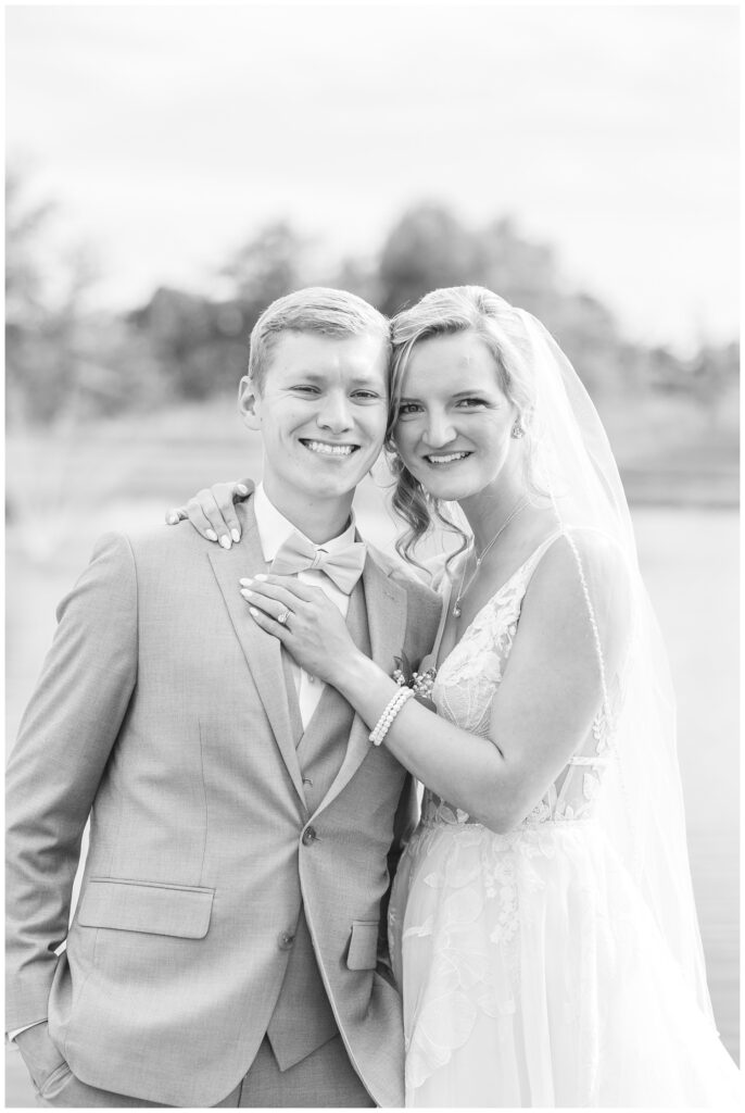 wedding couple smiling for couples portraits at Prairie Stone Farm venue