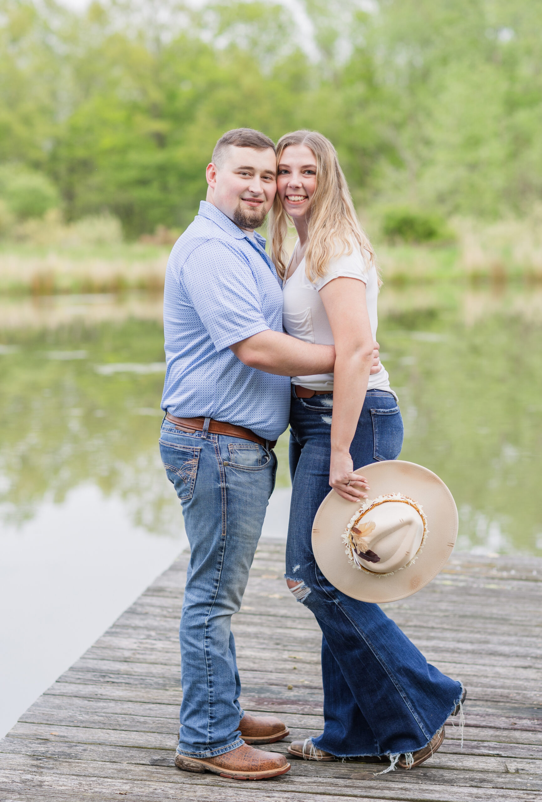 couple posing together on a dock on a pond in Ohio