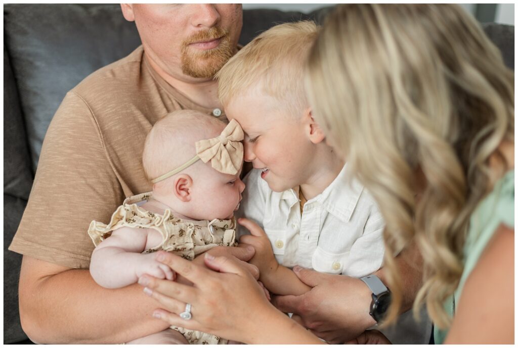 brother smiling at his baby sister for lifestyle newborn session in Fremont, Ohio