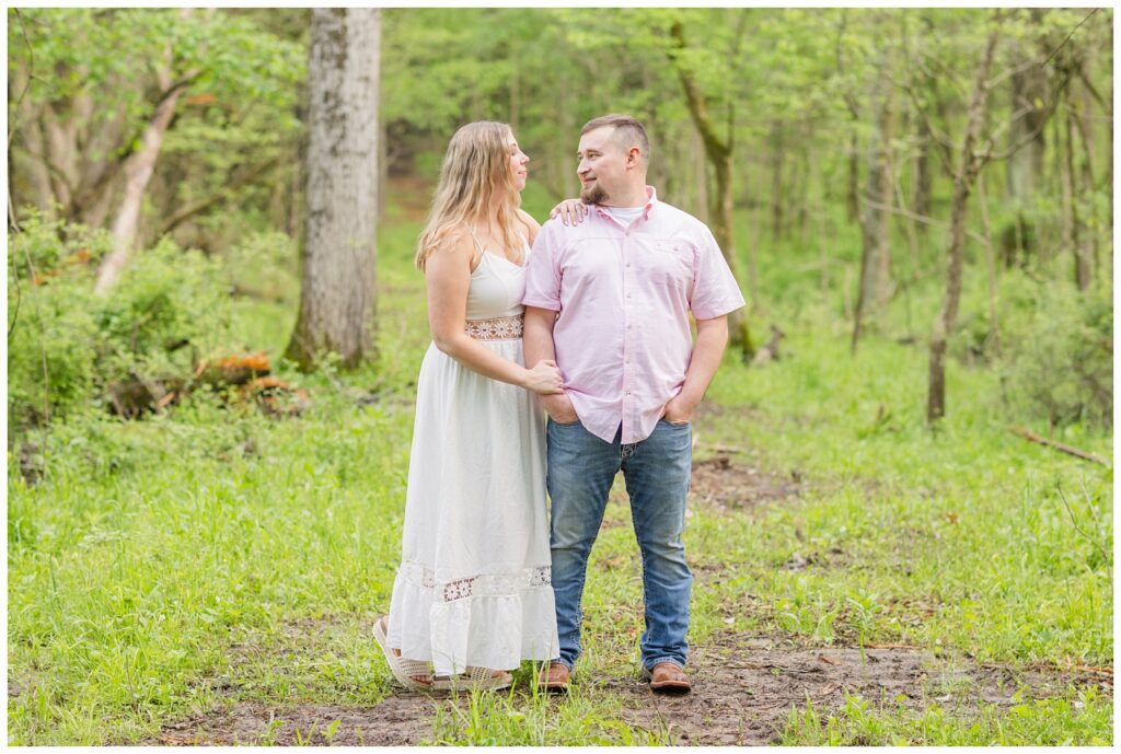 couple posing in the woods for engagement portraits in Willard, Ohio