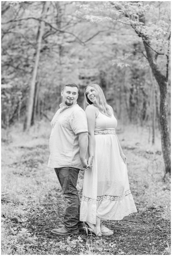 engaged couple standing back to back at northwest Ohio portrait session