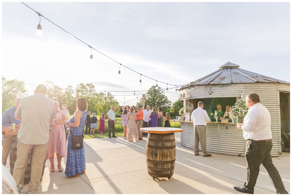 wedding guests enjoying cocktail hour on the patio from the silo bar