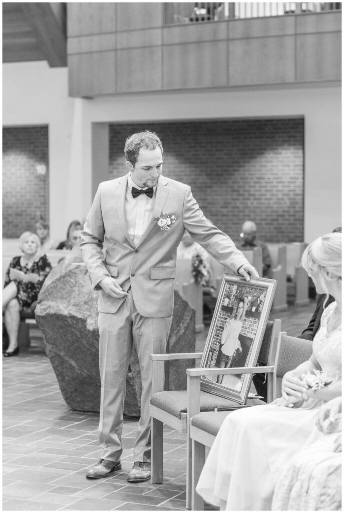 best man putting the bride's portrait of her mom on the front row at the church ceremony