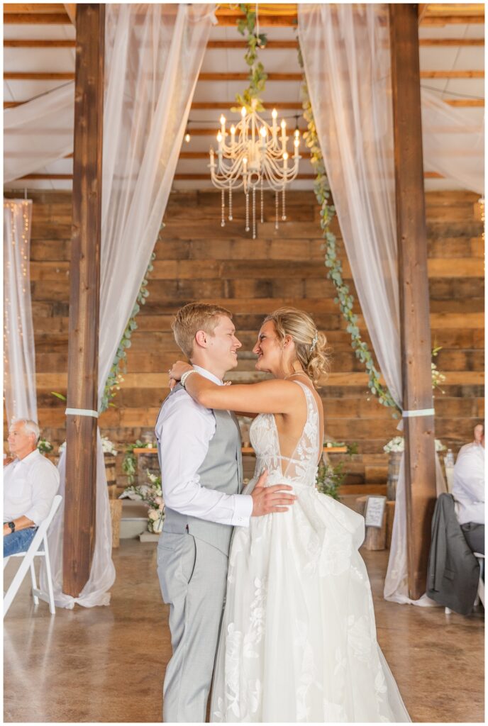 wedding couple have first dance in the barn at Prairie Stone Farm venue