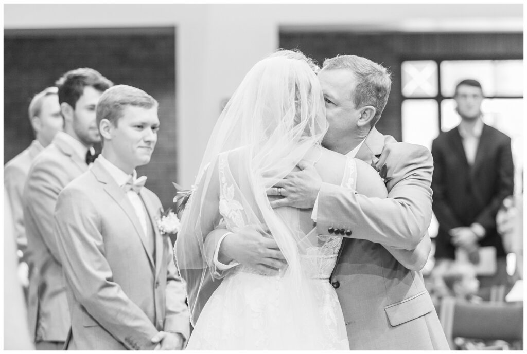 bride's dad giving her a hug as he gives her away to the groom in Dublin, Ohio