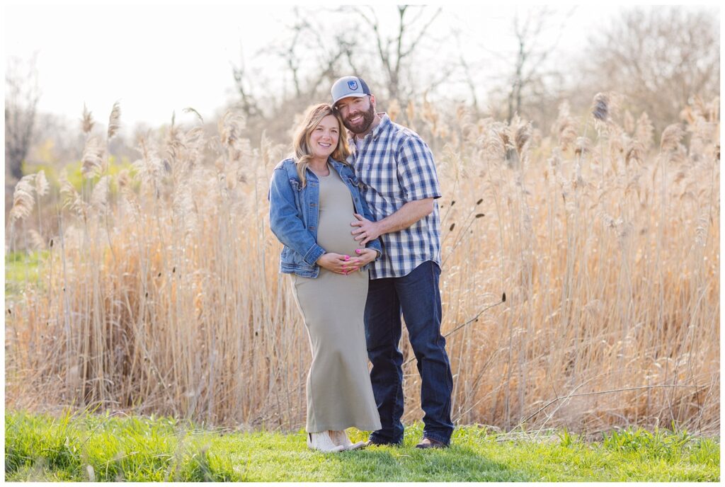 maternity session with couple posing in front of a tall field in Fremont, Ohio