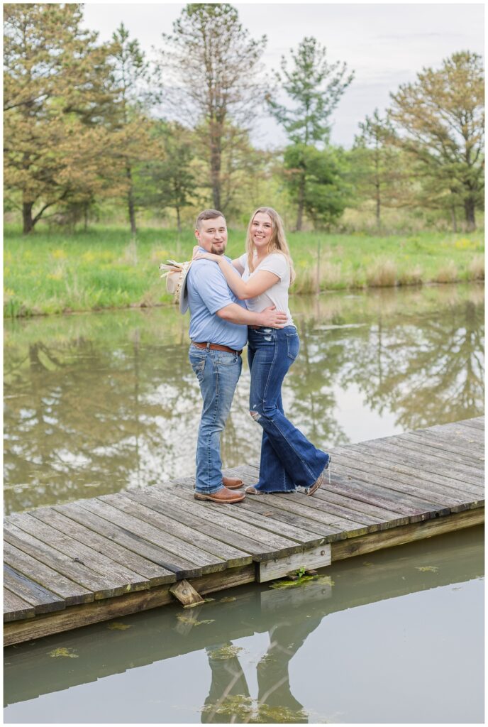 engagement couple posing on a dock with Sandusky, Ohio photographer