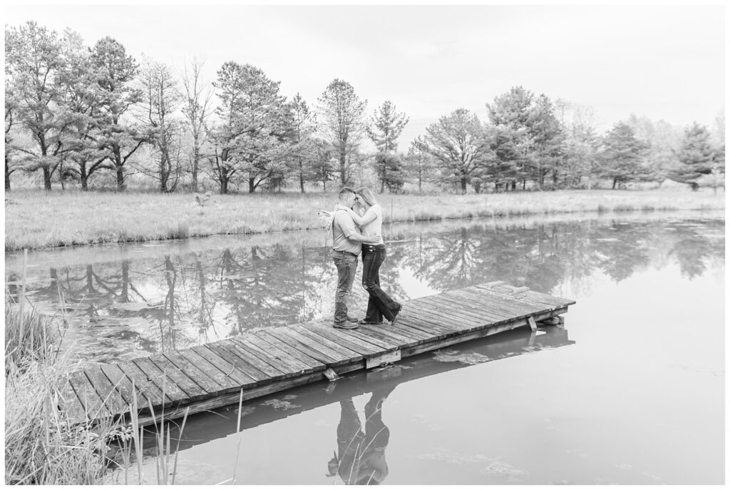 couple touching foreheads while standing on a dock for Ohio engagement session