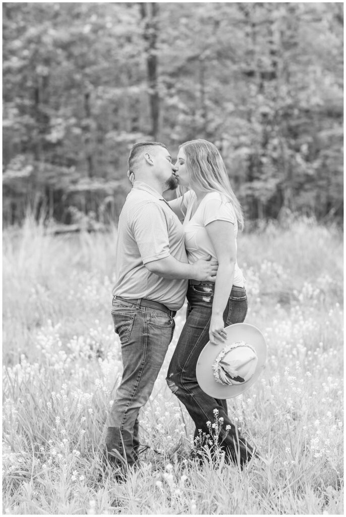 couple sharing a kiss in a flower field at Sandusky, Ohio engagement session