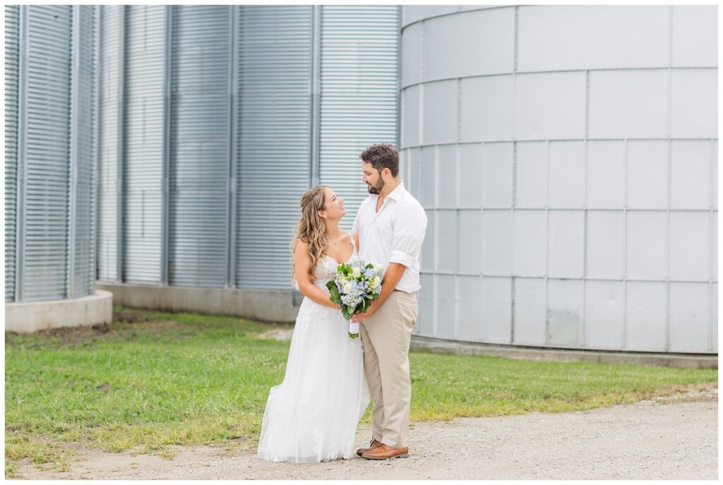 bride and groom holding the bouquet at Risingsun, Ohio wedding 