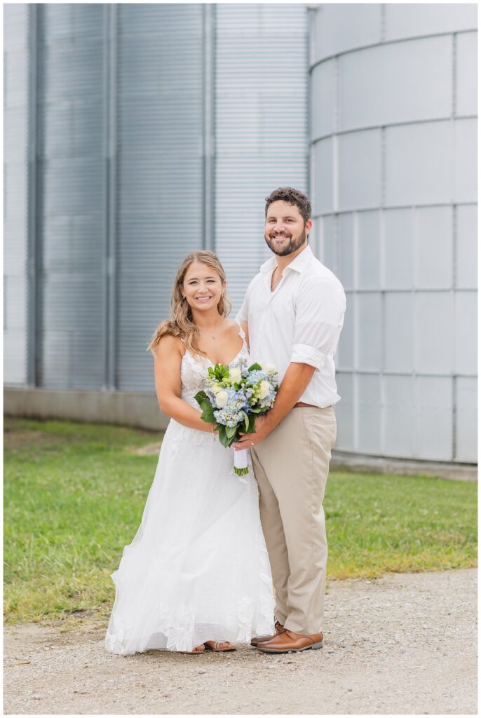 bride and groom holding the bouquet at Risingsun, Ohio country wedding 