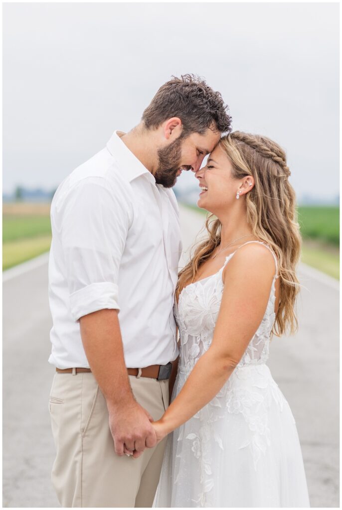 wedding couple laughing while in the middle of the road in Risingsun, Ohio