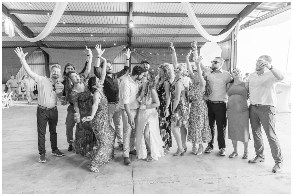 bride and groom posing with their friends at wedding reception in northwest Ohio