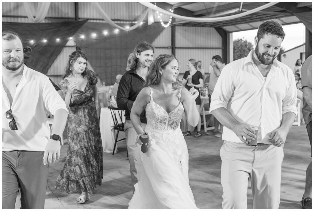 bride and groom dancing with wedding guests and drinking beer in Ohio