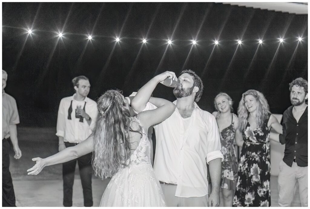 bride and groom interlocking arms and having a drink of beer at Ohio wedding reception