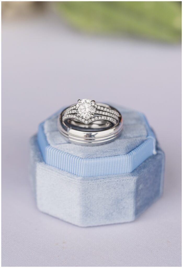 wedding rings sitting on top of a blue ring box in Risingsun, Ohio