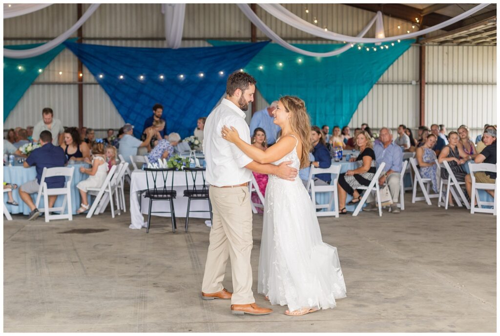 groom and bride share first dance at country wedding reception