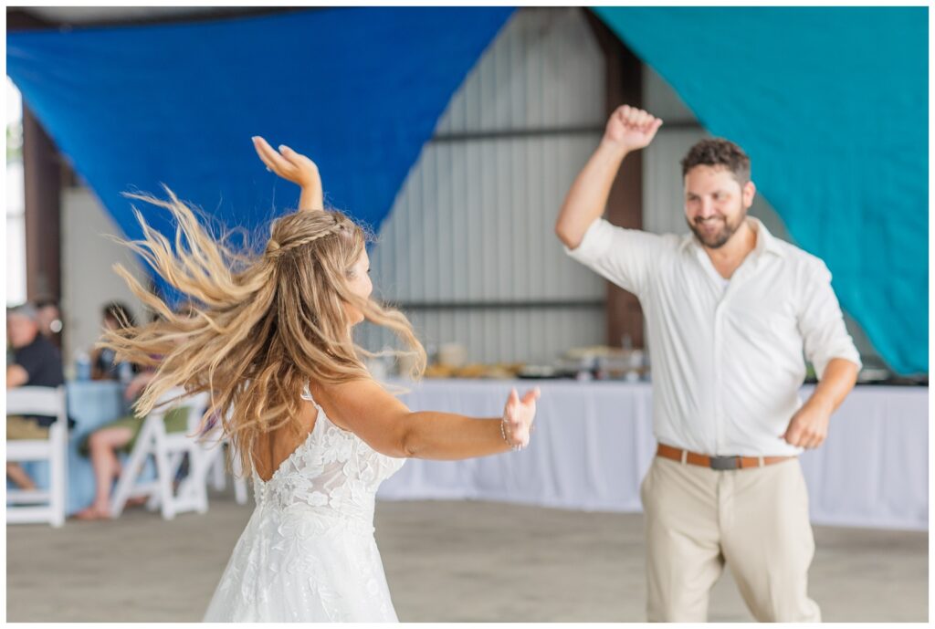 bride and groom finish first dance at family farm wedding reception in Ohio