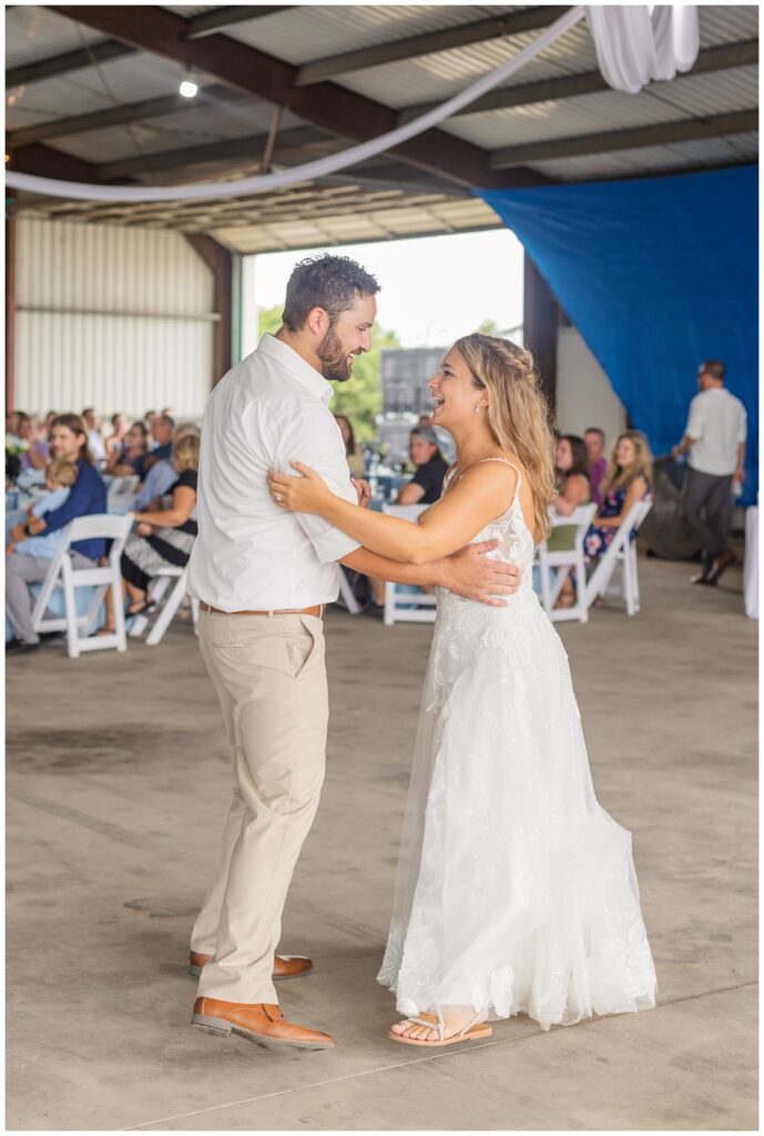 bride and groom finish first dance at family farm wedding reception in Ohio