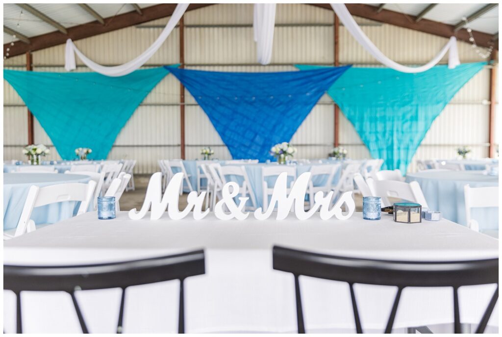 wedding couple sweetheart table in metal barn reception in Risingsun, Ohio