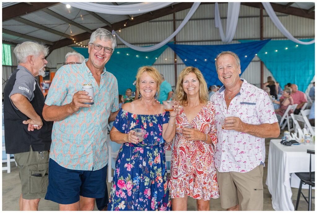 wedding guests posing at reception with drinks in Risingsun, Ohio