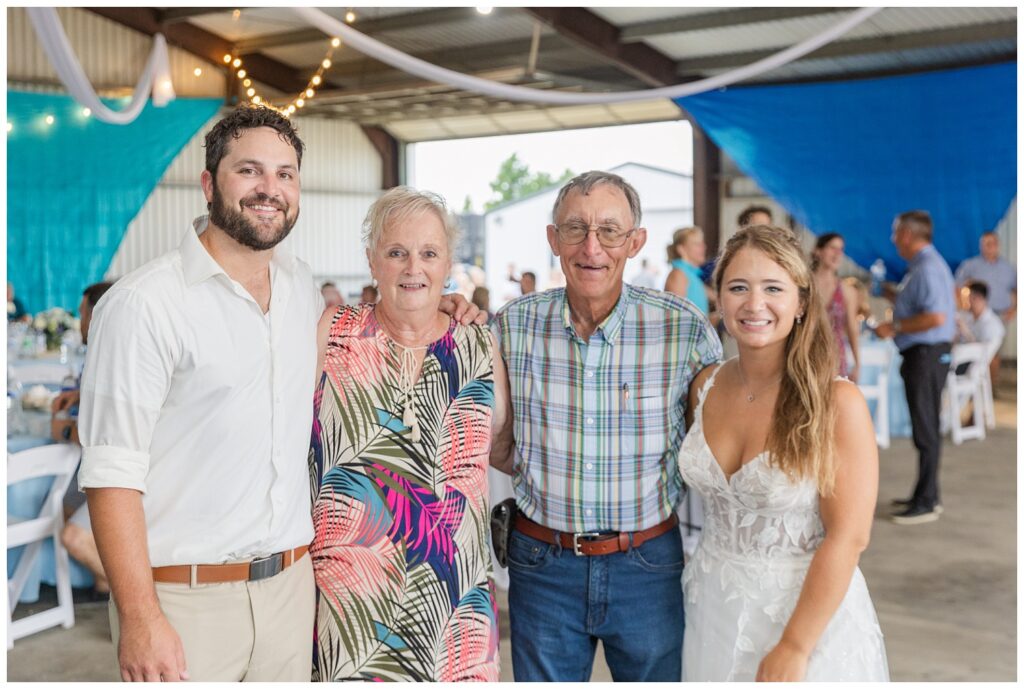 bride and groom posing with wedding guests after destination wedding 