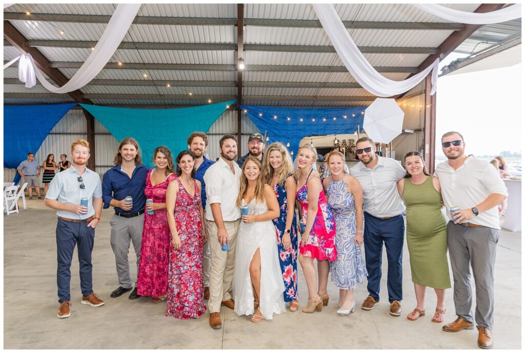 bride and groom posing with their friends at wedding reception in northwest Ohio