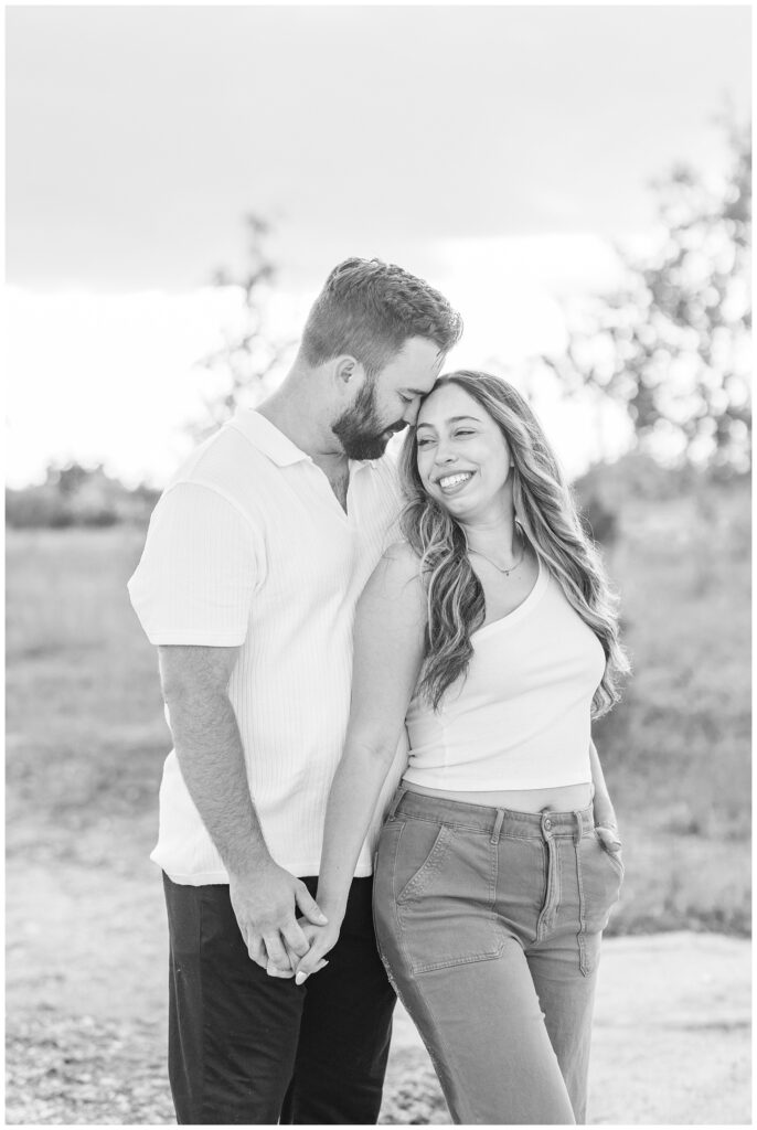 couple posing together next to a lake at a Silver Rock Quarry engagement session