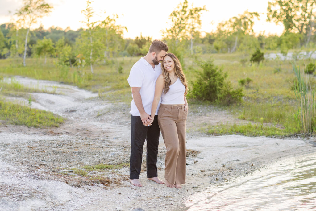 engagement couple posing next to a beach at the Silver Rock Quarry