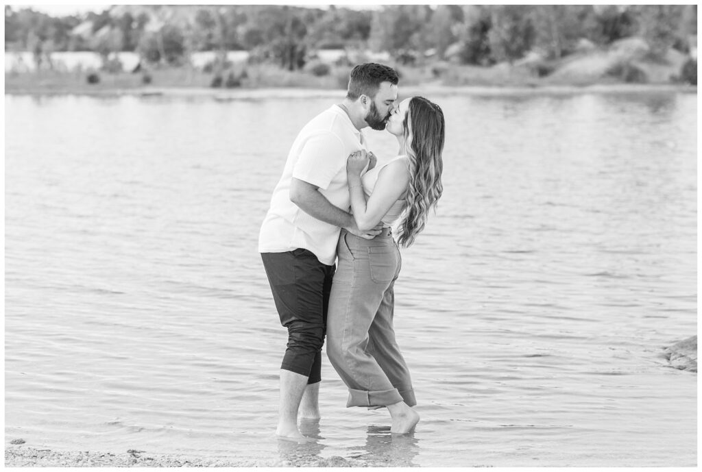 couple kissing while standing in the lake at Silver Rock Quarry engagement