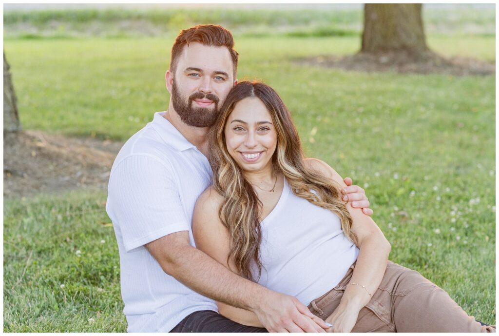 couple sitting together in the grass under some trees at Silver Rock Quarry