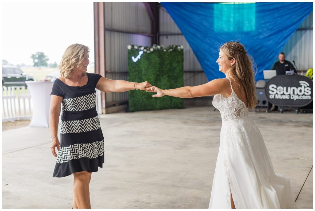 bride dancing with her mom in a metal barn at Risingsun, Ohio reception