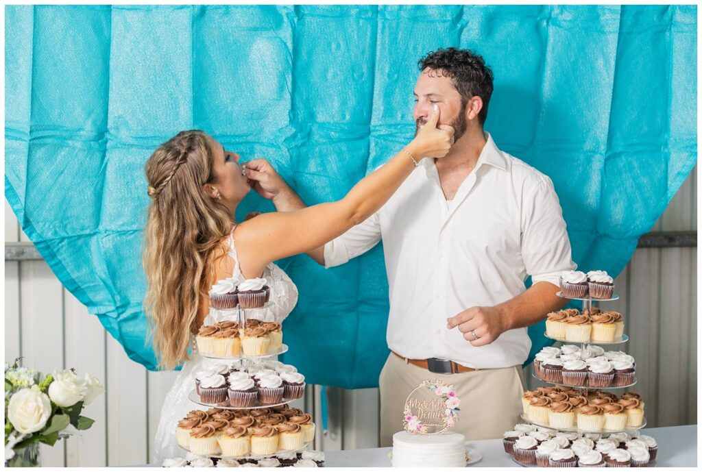 bride and groom feeding each other wedding cake at Risingsun, Ohio reception