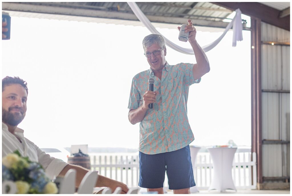 groom's dad giving a wedding toast at reception at family farm in Ohio