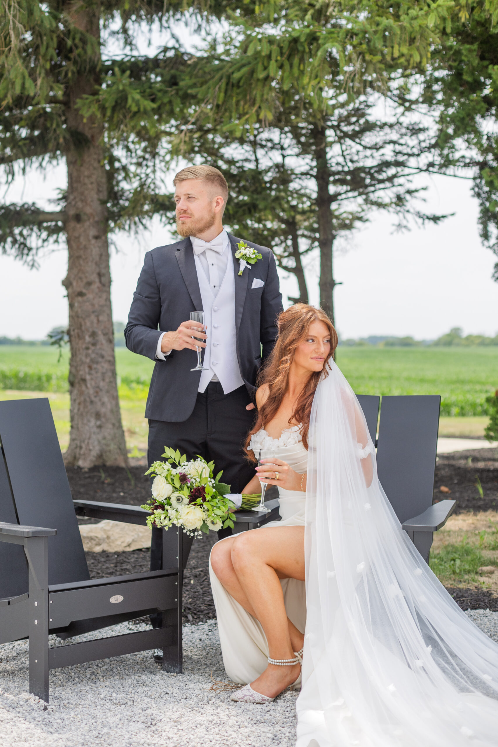 wedding couple posing in black Adirondack chairs in Tiffin, Ohio